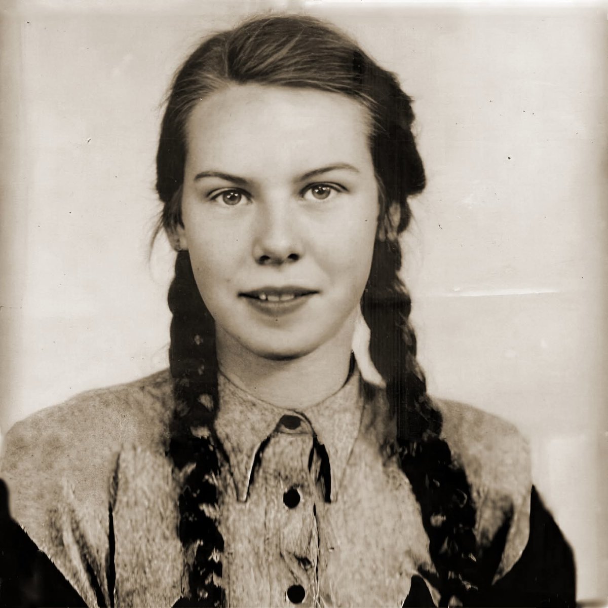 In May 1944, thirteen-year-old Elli Friedmann arrived at Auschwitz with her family after being deported from Hungary. She still had the long blond braids her mother used to carefully tend. On the ramp, everything was noise and terror—guards shouting, dogs snapping, families