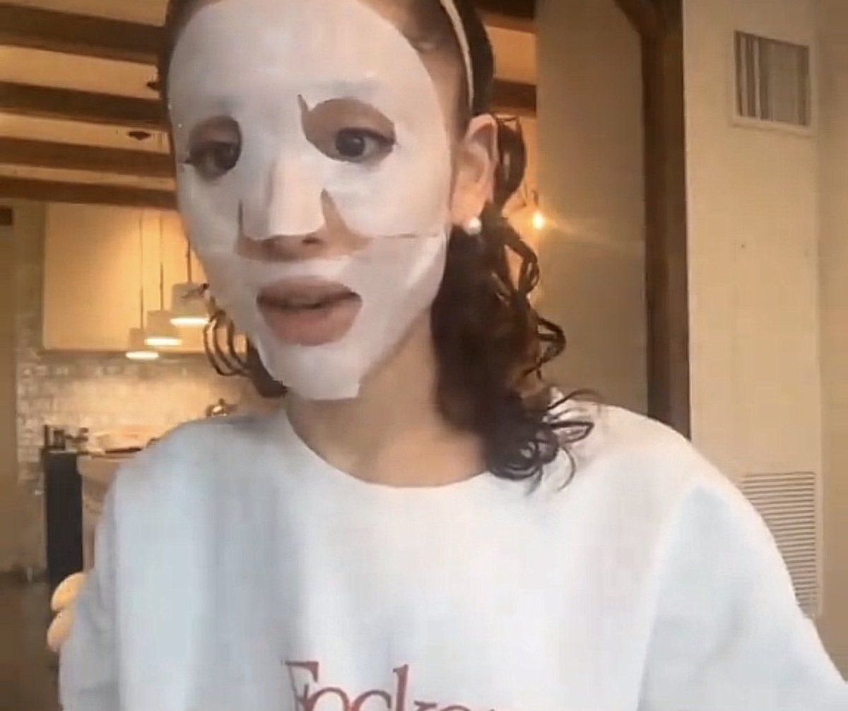 glindaupland's tweet photo. ariana grande shows off her brunette curly hair and focker in-law merch during new r.e.m. beauty video https://t.co/jfMMKgekuC