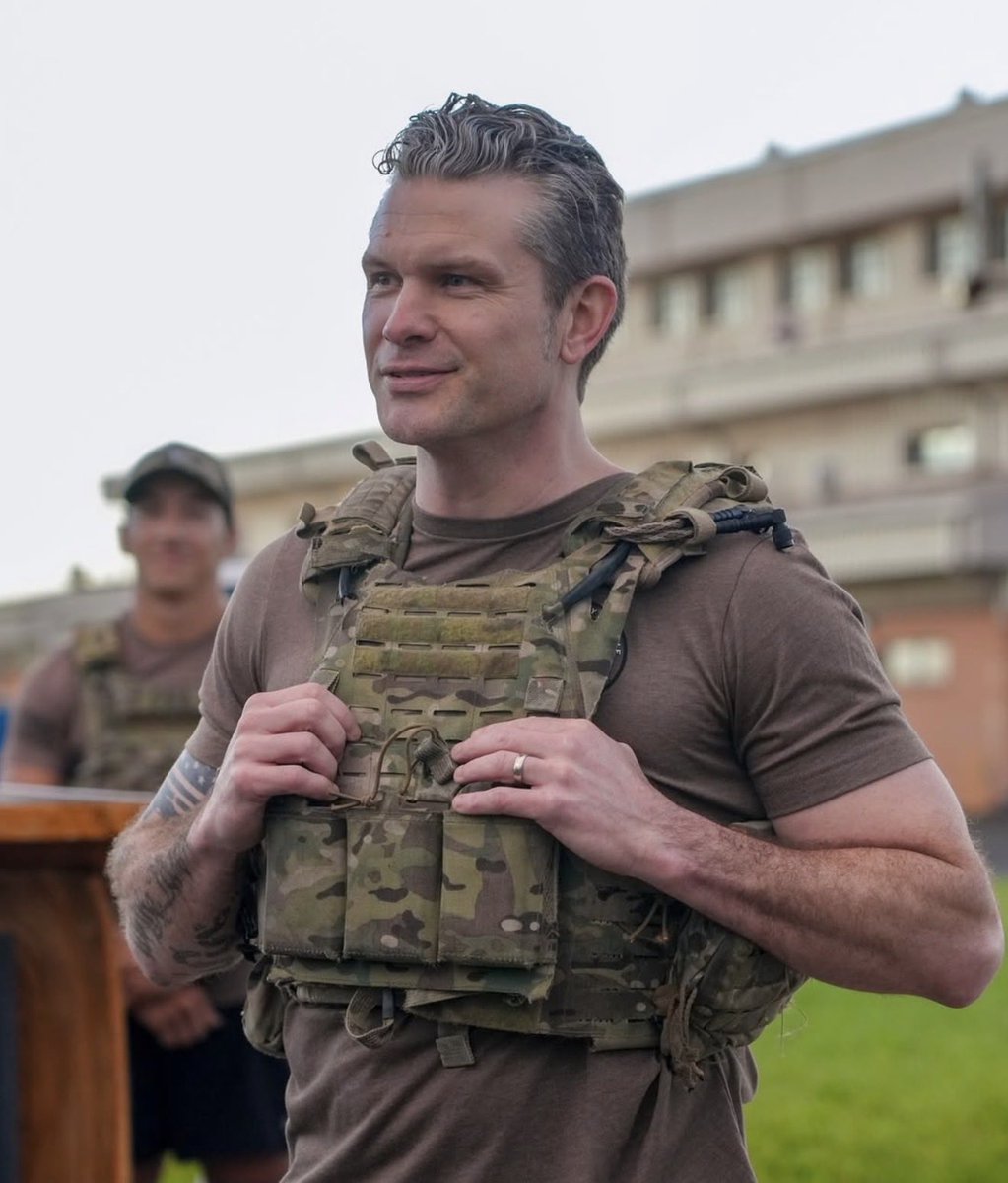 Who else stands with Pete Hegseth ?