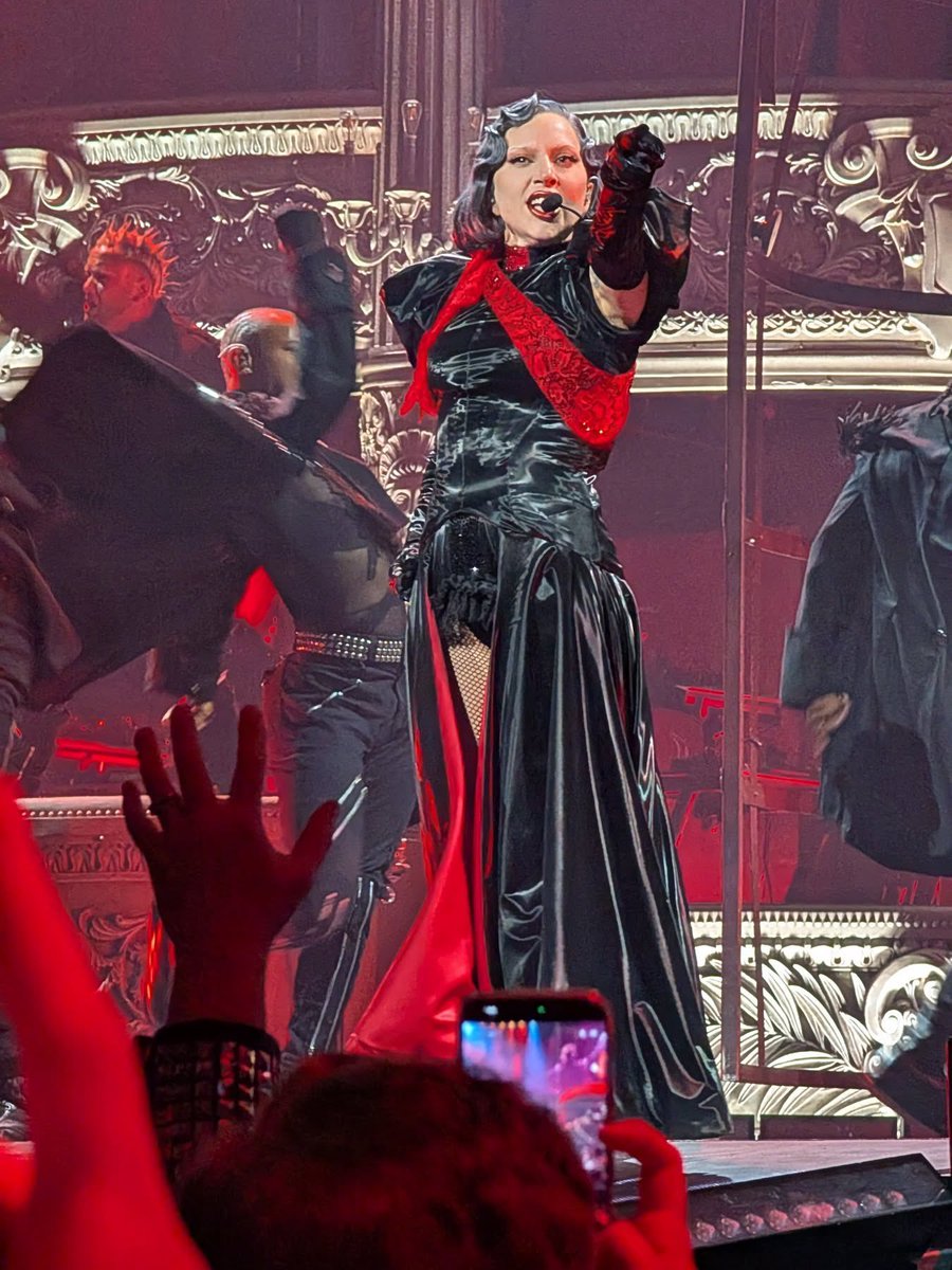Lady Gaga wore a brand new red lace sash over her black “Judas