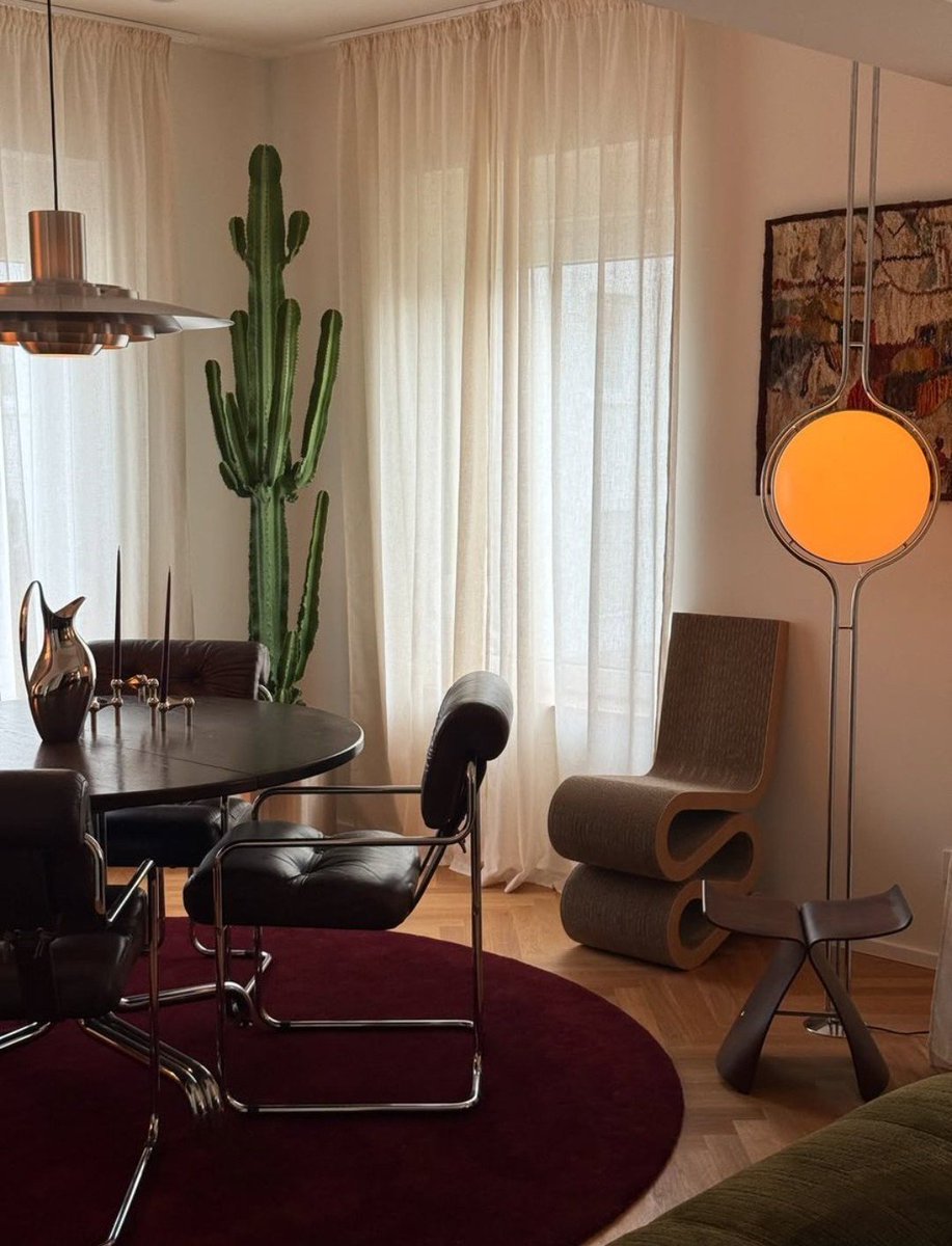 TOLLIstudio's tweet photo. Evening, calibrated. 
Low seating. Deep tones.
Paper lantern hovering like a quiet sun over walnut shelving.
Books form the grid. Lamps punctuate the rhythm.
Layered lighting creates intimacy without closing the room.
#AtmosphericDesign #WarmModern #LayeredLight https://t.co/1nEsTs8osN