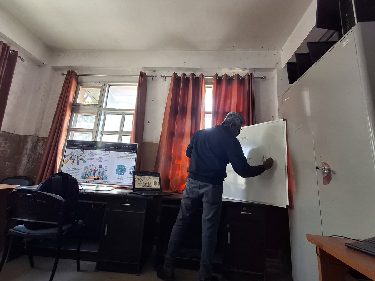 slackyay's tweet photo. Central University of Himachal Pradesh, and this is the state of a classroom: a professor teaching from a whiteboard balanced on a table because there isn’t even a proper board fixed to the wall. This is a Central University, not a roadside coaching centre. https://t.co/kWvZwcm75Z