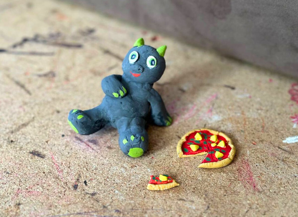 marnihihaho's tweet photo. If someone asked me what the main dish in Raiku is, I wouldn’t even hesitate. Anyone from our community would say the same thing - pineapple pizza. 

People love it here. It has somehow become part of our little community culture.

So at some point I got inspired to make a polymer clay figure that captures this vibe.
Our mascot Ryku the dragon just chilling after enjoying some pineapple pizza. Judging by his happy belly, he had a good meal.

The only question left is:
how many pizzas do you think he ate? 😄

@raikucom