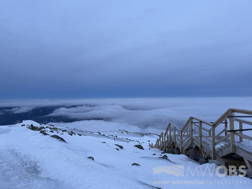 Summit staff enjoyed a great view of a partial undercast yesterday evening. A strong storm will bring warm, wet, and windy conditions to the higher summits on Saturday, with 100+ mph wind gusts and temperatures in the 40s possible.