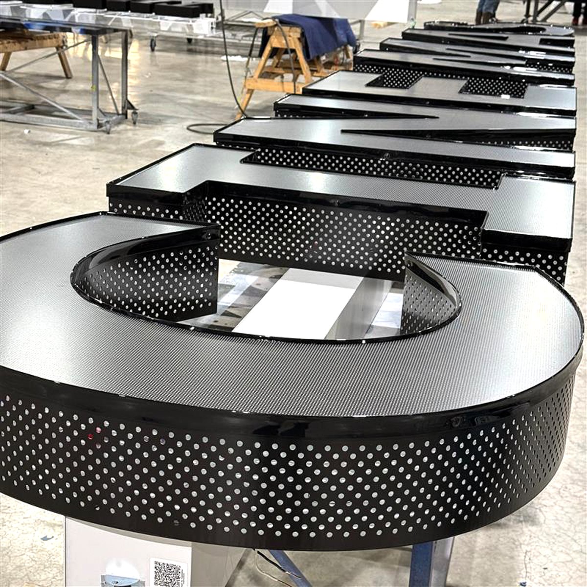 Custom perforated returns let this sign's glamour shine through raceway ...