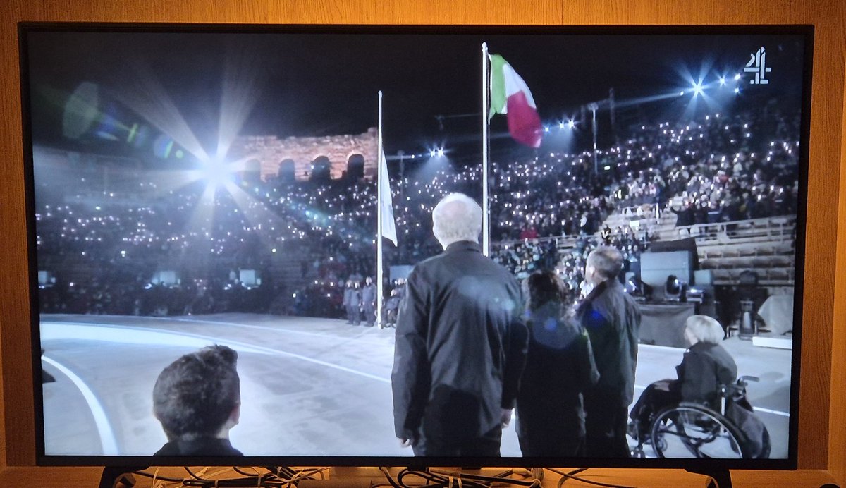 TVSimes's tweet photo. An arena of people from all over the world united under a flag of the Olympic Games. A shame this very same world cannot unite under a flag of peace. #milano2026 #ParaOlympics #C4News #C4 https://t.co/caDSsObdu4