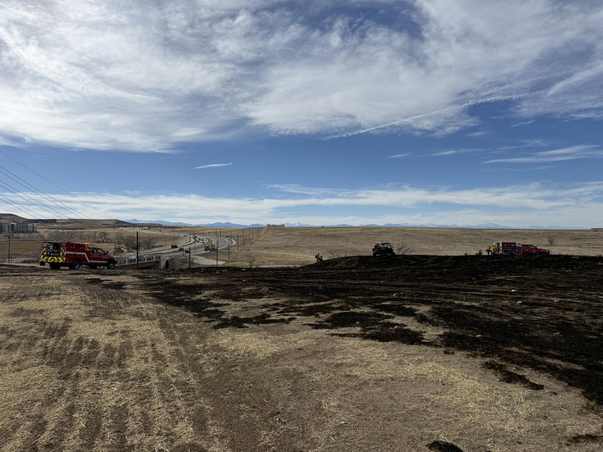 Update: Crews continuing to mop up and extinguish any remaining hot spots. One lane WB Ridgegate Pkwy now open. Cause of the fire is under investigation by SMFR Fire Marshal’s Office. 65 personnel from South Metro Fire Rescue responded with a crew from Douglas County Office of