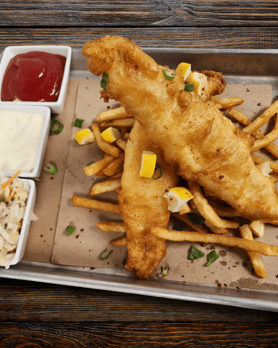 Looking for comfort food done right? Try our Fish &amp; Chips! Crispy beer-battered cod, perfectly cooked fries, tangy slaw, and tartar sauce. A true classic. 

Visit Sitting Duck Tavern today! 
sittingducktavern.com

#SittingDuckTavern #CommunityFirst #LocalEats