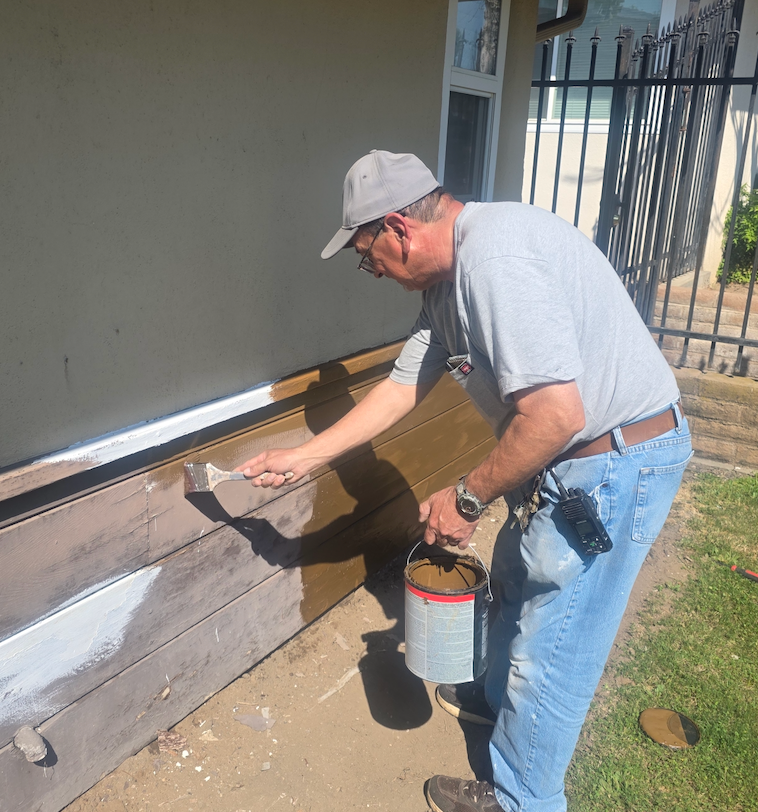 Master Maintenance Man, Rudy, at work. First is paint to brighten up the wood. Next are flowers to brighten up everything!