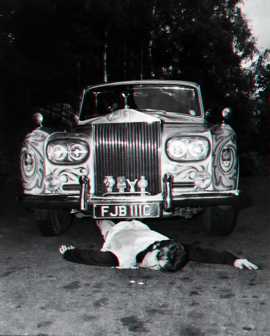 John Lennon, pretending to have been run over by his Rolls-Royce.