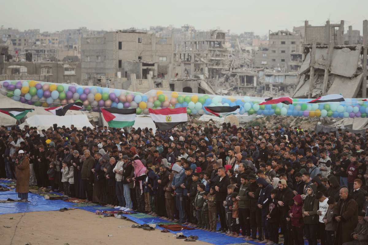 Palestinian Muslims offer Eid al-Fitr prayers amid the rubble of destroyed buildings in Jabaliya, Gaza Strip