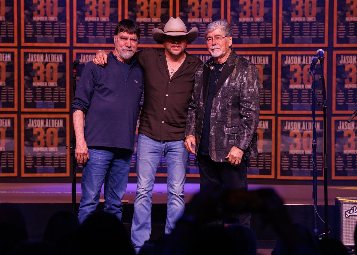 Jason_Aldean's tweet photo. Thought I was just showing up to play a song and head home, and y’all turned it into a surprise #1 party.

To every songwriter that’s been a part of my records, this is because of you. Y’all are the reason I get to do what I do.

To the country radio programmers who take a chance on the songs and keep playing them… you’re the reason these records get heard.

@BBRMusicGroup, Maverick and everybody who’s been with me the last 20 years… I appreciate it more than you know. Still blown away by Thursday night. 🙏

📸: Jeff Johnson