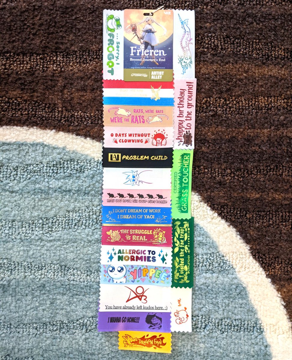 KiRAWRart's tweet photo. Here's a closer look at the tiiiiniest 🤏 pins from @StarGarnish and @SunnySponder, plus my final badge ribbon train!

#ECCC26 #ECCC #pincollector https://t.co/rX30SnXHvK