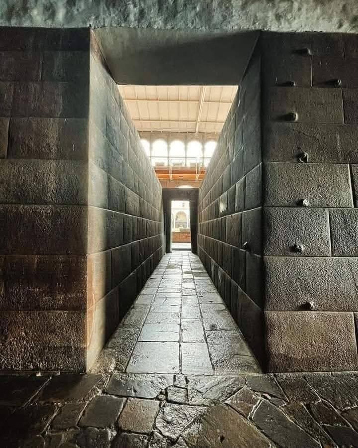 This monumental stone corridor is located inside the sacred temple complex of Qorikancha in Cusco, the ceremonial heart of the Inca Empire in Peru. Originally constructed during the 15th century, the temple was dedicated to the sun god Inti and served as one of the most important
