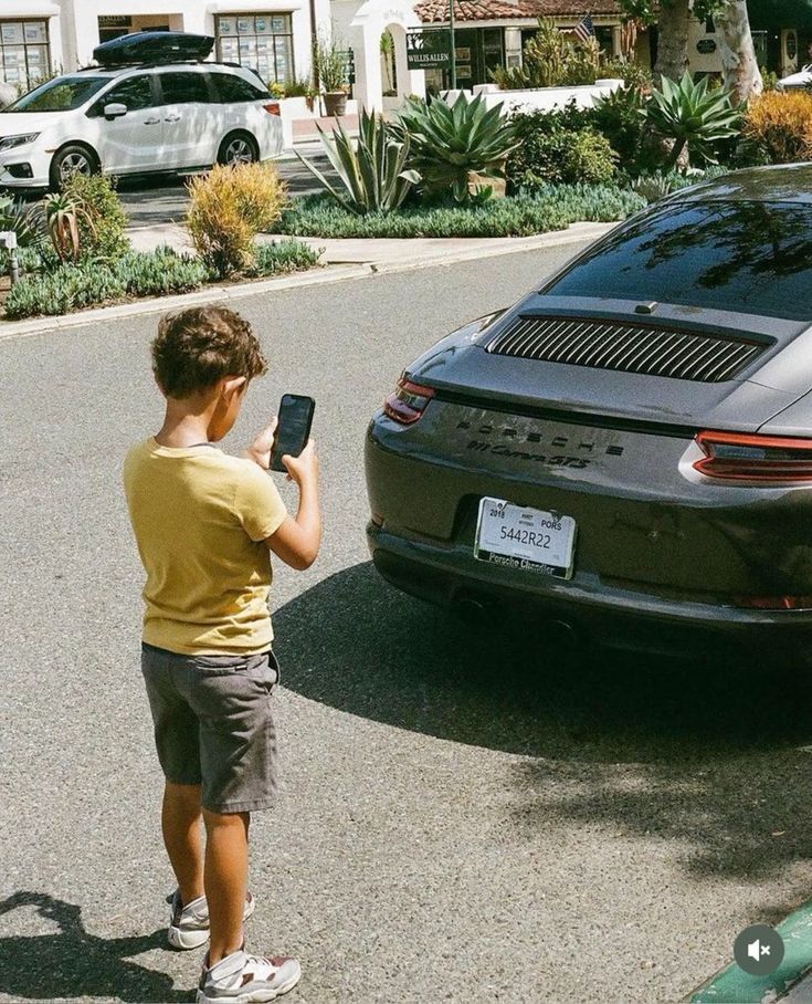 One day that little boy wont be taking pictures of a Porsche 911 Carrera GTS.
He'll be walking toward the driver's door. That's you brother