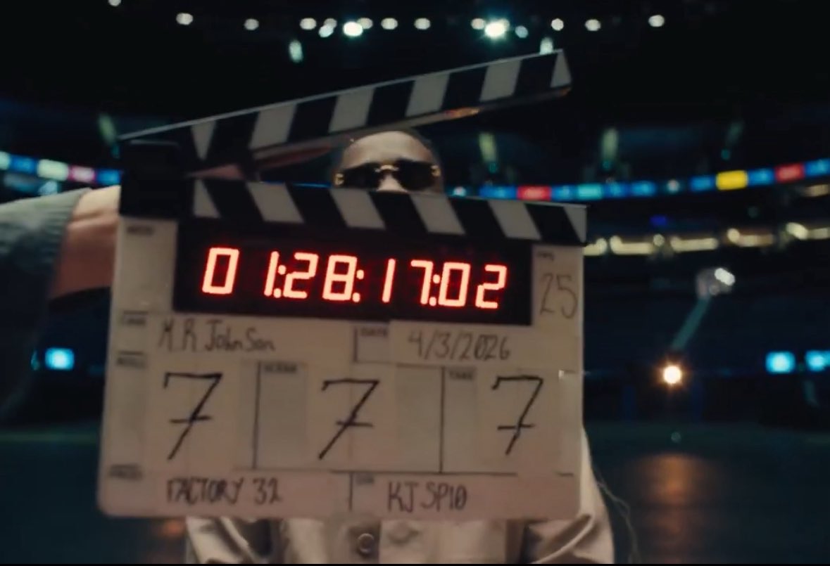 thejosephmireku's tweet photo. Well, since you asked, here we go:

The scene opens with an “a capella” rendition of lyrics referencing his goal of selling out the O2. This seems normal. But if you look closely, you see he’s set against a red backdrop, which is strange because for filming and production, you would normally expect a greenscreen. Straightaway we see the “eye-red”, the sweat, the blood, and the suffering creating the background with which he has gotten so far.

The red serves a hidden purpose too. The red cape is what a matador waves in front of an angry charging bull. Throughout his career, he has had these big charging bulls always attacking his progress. This is the moment where he waves the red cape. Though entertaining for his admirers and fans, it will inevitably lead to the humiliation of the charging bulls. 

The red also recalls the campaign around the Alpha album, where red was heavily used as the central visual theme, and it eventually became the colour scheme for that year’s Rapperholic concert in 2019 (7th edition. We will come to this later).

Moving on, the camera pans out and we see a clapperboard showing 777. Sarkodie likes to rap about his hustle, but which song is his most personal and powerful exploration of his suffering? Mile 7 Freestyle. The show will also take place in 2027, on the occasion of Ghana’s 70th Independence Anniversary. You might think it’s 7 not 70 so this is stretching it, but..Sarkodie was born on 10 July, i.e the 10th day of the 7th month. 10*7 gives you 70. Interestingly, the 2019 Rapperholic concert, which carried the strong red theme during the Alpha campaign, was also the 7th edition of Rapperholic.

Finally, Sark is looking at the viewer mot of the time, but just when the actual shoot starts with the clapperboard, he begins to walk away. He wants you to come with him on this journey. He wants you to be part of this historic moment.