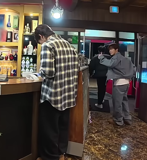 dino giving a thumbs up before he leaves while joshua pays for the whole meal for svt and the gose staff (after losing a game)