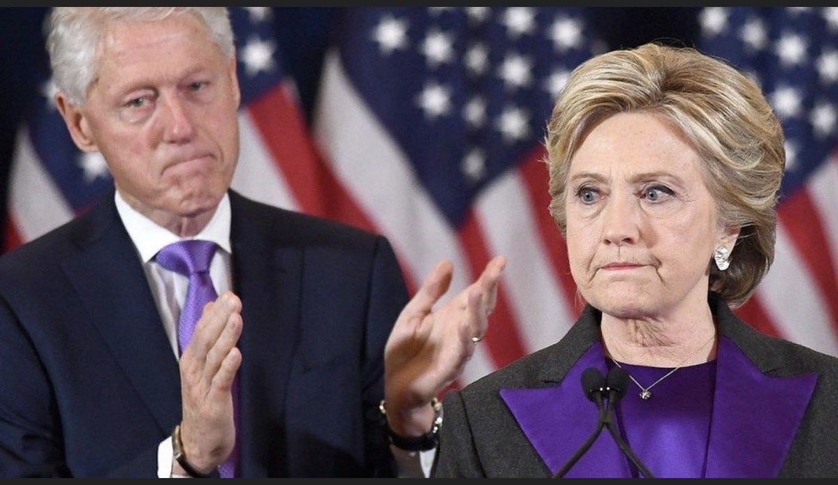 stephensleigh's tweet photo. @MattWallace888 Hillary and Bill wore purple on the day after Trump won in 2016.  What was that signaling?  Purple (red and blue combined) = Uniparty https://t.co/oCJWMUDWZ8