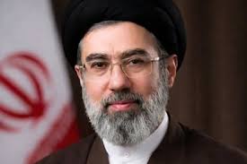AlanEyre1's tweet photo. 1st Mojtaba statement (machine translation):

In the name of Allah, the Merciful
We don't copy from a verse or a parable. [Quote from Quran]

Peace be upon you or Da'ee Allah and Rabbanyi His verses, Peace be upon you or God of God and Dayan Dinah, Peace be upon you or Caliph of God and Nasser Haqqah, Peace be upon you or The proof of Allah and the proof of His will; Peace be upon you, O foremost hope; Peace be upon you, O Lord of the worlds; Peace be upon you, O Lord of the time.

At the beginning of my speech, I must express my condolences to my Lord, may God hasten his return, on the occasion of the heartbreaking martyrdom of His Excellency the Great Leader of the Revolution, the Wise Khamenei, and ask His Holiness to pray for the good of each and every great nation of Iran, and indeed all Muslims of the world, and all servants of Islam and the revolution, and the martyrs and survivors of the martyrs of the Islamic movement, especially the recent war, and for myself.

The second part of my speech is to the great nation of Iran. First, I must briefly state my situation and position regarding the vote of the esteemed Assembly of Experts. This servant of yours, Seyyed Mojtaba Hosseini Khamenei, learned about the outcome of the vote of the esteemed Assembly of Experts at the same time as you and through the Islamic Republic of Iran. It is difficult for me to sit on the seat that was once the seat of two great leaders, the great Khomeini and the martyr Khamenei. Because this seat has the history of sitting on someone who, after more than 60 years of striving for the cause of God and forgoing all kinds of pleasures and comforts, has become a shining gem and a distinguished figure not only in the present era but throughout the history of the rulers of this country. Both his life and the manner of his death were imbued with the glory and dignity that comes from relying on the truth. I had the opportunity to visit his body after his martyrdom; what I saw was a mountain of strength and I heard that his healthy hand was clenched in a fist. Those who are knowledgeable will have to say a lot about the various aspects of his personality. At this point, I will suffice with this summary and leave the details to other appropriate occasions. This is the reason for the difficulty of relying on the leadership seat after such a person. Closing this gap is only possible with the help of the Almighty and the help of you, the people.

Next, I need to emphasize a point that is directly related to the essence of my words. That point is that among the arts of the martyred leader and his great predecessor was to involve the people in all areas and to continuously provide them with insight and awareness, and to rely on their strength in practice. In this way, he actualized the true meaning of the republic and the republic, and he believed in it from the bottom of his heart. The clear effect of this was seen in these few days when the country was without a leader and without a commander-in-chief. The insight and intelligence of the great Iranian nation in the recent incident, and its steadfastness, courage, and presence, made friends admire and enemies be amazed. It was you, the people, who led the country and guaranteed its authority. The verse that I have mentioned at the beginning of this article means that there is no verse of the divine verses that either expires or is forgotten unless it is replaced by something similar or better than it by the Almighty.

The reason for using this noble verse is not that I am on the level of the martyred leader, let alone that I want to be considered superior to him; rather, the purpose of mentioning the blessed verse is to pay attention to the worthy and prominent role of you, the dear nation. If that great blessing was taken away from us, instead, the Iranian nation was once again given the presence of a builder-like presence in this system. Know this: If your power does not appear on the scene, neither the leadership nor any of the various institutions whose true status is to serve the people will have the necessary efficiency. In order for this meaning to be better realized, first, the remembrance of God Almighty, trusting in His Majesty, and resorting to the pure lights of the infallibles, may God bless them all, should be viewed as the greatest elixir and red match that guarantees all kinds of openings and a definitive victory over the enemy. This is a great advantage that you possess and your enemies lack.

Secondly, the unity between individuals and classes of the nation, which usually finds a special expression in times of hardship, should not be undermined. This will be achieved by disregarding the points of disagreement.

Thirdly, an effective presence on the scene should be maintained; whether in the way you have shown yourself in these days and nights of war or in the form of various effective roles in various social, political, educational, cultural, and even security fields. What is important is that the correct role is well understood and implemented as much as possible without compromising social unity. One of the duties of the leadership and some other officials is to remind individuals or segments of society of some of these roles. Therefore, I would like to remind everyone of the importance of attending the Quds Day 1447 ceremony, in which the element of breaking the enemy should be the focus of everyone's attention.

Fourth, do not neglect helping and assisting each other. Thank God, this is the usual characteristic of most Iranians, and it is expected that this will be more evident in these special days, when naturally some members of the nation are having a harder time than others. On this occasion, I ask the service organizations not to hesitate to provide any kind of help and assistance to those dear members of the nation and to the popular relief structures in this regard.

If these aspects are observed, the path to your dear nation's days of greatness and glory will be smooth. The closest example of this can be, God willing, victory over the enemy in the current war.

The third part of my speech is my sincere gratitude to our brave warriors who, in the conditions where our beloved nation and homeland have been unjustly attacked by the leaders of the arrogant front, have blocked the enemy's path with their crushing blows and have removed them from the illusion of the possibility of dominating the beloved homeland and possibly dividing it.

Dear brother warriors! The demand of the masses of the people is to continue the effective and regrettable defense. Also, the lever of blocking the Strait of Hormuz must definitely continue to be used. Studies have been conducted on opening other fronts where the enemy has little experience and will be extremely vulnerable in them, and their activation will be carried out if the war situation continues and based on the observance of interests.

I also sincerely thank the warriors of the Resistance Front. We consider the countries of the Resistance Front to be our best friends, and the cause of resistance and the Resistance Front are an inseparable part of the values ​​of the Islamic Revolution. Undoubtedly, the solidarity of the components of this front will shorten the path to liberation from the Zionist sedition; as we have seen, the brave and faithful Yemen did not stop defending the oppressed people of Gaza, and the devoted Hezbollah has come to the aid of the Islamic Republic despite all obstacles, and the Iraqi resistance has also courageously taken the same line.

In the fourth part, I will address those who have been harmed in some way in these past few days. Whether those who have experienced the martyrdom of a loved one or loved ones; those who have been injured; or those whose homes or businesses have been damaged. In this part, first of all, I express my deep sympathy for the survivors of the high-ranking martyrs. This is based on the common experience that I have with these noble people; Apart from my father, whose loss has become a public matter, I have left my dear and loyal wife, whom I had high hopes for, my devoted sister, who had devoted herself to serving her parents and had finally received her reward, as well as her young child and my other sister's husband, who was a learned and honorable person, to the caravan of martyrs. But what makes patience in the face of adversity possible and even easy is paying attention to the certain and certain promise of God of a precious reward for the patient. Therefore, one must be patient and have hope and trust in the grace and protection of the Almighty.

Secondly, I assure everyone that we will not refrain from avenging the blood of your martyrs. The revenge we are considering is not only related to the martyrdom of the great leader of the revolution; rather, every member of the nation who is martyred by the enemy is an independent subject for the revenge case. Of course, a limited amount of this revenge has been realized so far, but until it is fully achieved, this case will continue to be on top of other cases, and we will be especially sensitive to the blood of our children. Therefore, the crime that the enemy deliberately committed in the case of the Shajarah Tayyiba Minab School and some similar cases has a special place in this investigation.

Thirdly, the veterans of these attacks must receive appropriate medical services free of charge and benefit from some other benefits.

Fourthly, to the extent that the current situation allows, adequate measures must be defined and implemented to compensate for the financial damages caused to personal properties and premises. The last two cases are a mandatory obligation for the respected officials, who must implement them and report them to me.

The point I must point out is that in any case we will receive compensation from the enemy and if he refuses, we will take as much of his property as we determine, and if that is not possible, we will destroy the same amount of his property.

The fifth part of the speech is addressed to the leaders and influential ranks in some of the countries of the region. We have 15 neighboring countries on land or sea and have always been and are willing to have warm and constructive relations with all of them. However, the enemy has been gradually establishing military and financial bases in some of these countries for years in order to secure its dominance over the region. In the recent attack, some military bases were used, and naturally, as we had explicitly warned, we simply attacked those bases without attacking those countries. From now on, we will inevitably continue to do so; although we still believe in the need for friendship between ourselves and those neighbors. These countries must make their duty clear to the invaders of our beloved homeland and the murderers of our people. I recommend that they close those bases as soon as possible; because they must have realized by now that the claim of establishing security and peace by America was nothing more than a lie.

This will make them more connected with their own nations, who are generally dissatisfied with their association with the infidel front and its humiliating behavior, and will increase their wealth and power. I repeat again that the Islamic Republic system, without wanting to establish domination and colonialism in the region, is fully prepared for unity and warm and sincere mutual relations with all its neighbors.

In the sixth part of the speech, I will focus on our martyred leader. Leader! With your departure, you have brought a heavy burden to everyone's hearts. You have always yearned for this outcome until finally, the Almighty God granted it to you while reciting the Holy Quran on the morning of the tenth day of Ramadan. You have endured many injustices with authority and patience and have not frowned. Many have not recognized your true worth, and perhaps it will be a long time before the various veils and obstacles along the river and its corners become clear.

We hope that from the position of proximity that has been provided for you next to the lights of the righteous, the martyrs, and the saints, you will still think about the progress of this nation and all the nations of the resistance front and intercede for it; just as you did in your worldly life. We pledge with you that for the elevation of this flag, which is the main flag

In the seventh part, I would like to thank all the nobles who have supported me, including the great religious authorities and various cultural, political, and social figures, and the people who have attended the magnificent gatherings to express renewed allegiance to the regime, as well as the officials of the three branches of government and the interim leadership council for their good measures and actions.

I hope that the special grace of God will encompass the entire Iranian nation in these blessed hours and days, and indeed all Muslims and the oppressed people of the world.

And finally, I ask our Lord, may God hasten his return, to seek from the Almighty God, in the remaining nights and days of power and the blessed month of Ramadan, a decisive victory for our nation over the enemy, as well as dignity, expansion, and well-being, and for their departed ones, positions and well-being in the hereafter.

Peace be upon you, and may God's mercy, blessings and greetings be upon you.
Sayyid Mujtaba Hosseini Khamenei
21 / Esfand / 1404 Corresponding to
22 / Ramadan / 1447