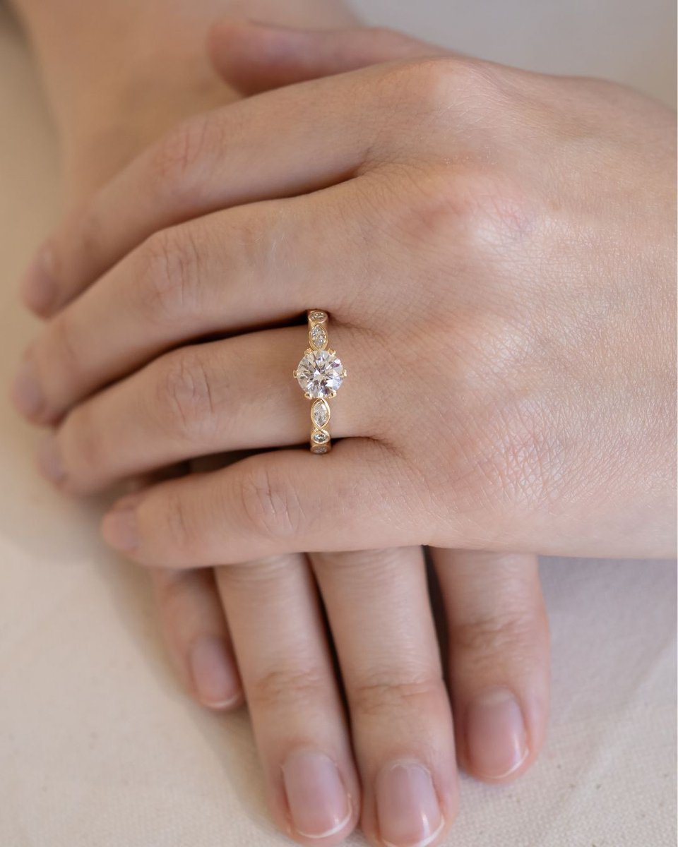 Introducing the Round Crown Set Engagement Ring. Handcrafted in 18ct yellow gold, with a radiant round centre diamond and pear and round side stones totalling 0.28ct. Timeless, refined, and made to be worn for a lifetime. 

#engagementrings #engagementringinspo