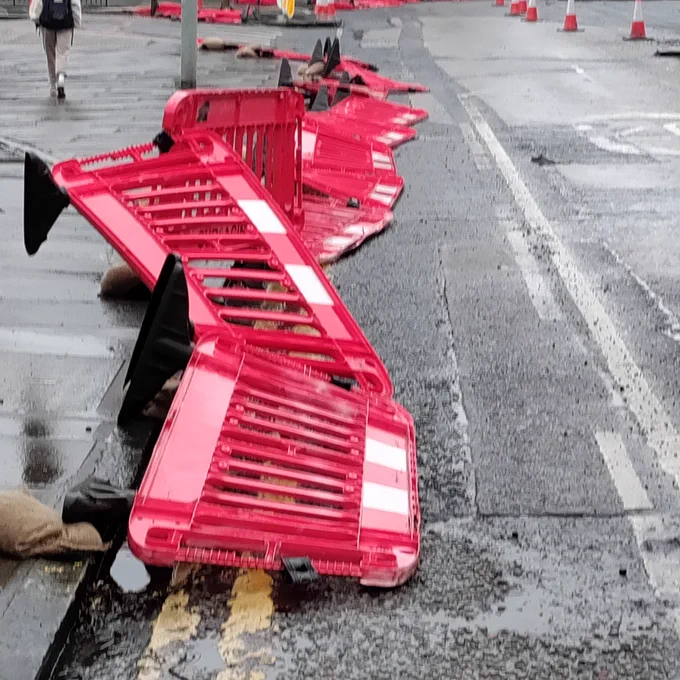 Unsecured barriers spilling into the roadway / cycle lane.