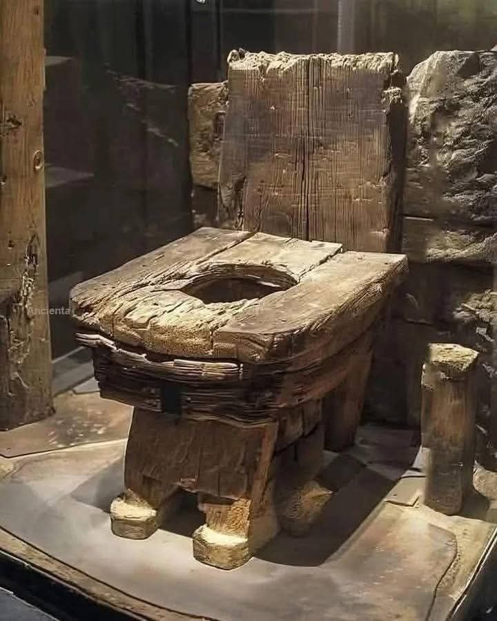 Discovered during excavations in Northern Europe, likely England or Germany, this remarkably preserved wooden latrine dates to approximately the 14th–15th century during the Late Middle Ages. Constructed from thick oak planks bound together with iron fittings, the seat features a