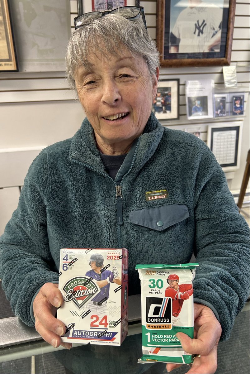 A surprised customer at ATTACK OF THE BASEBALL CARDS, showing off Free gifts she received as ATTACK celebrates its 44th Anniversary today!!!