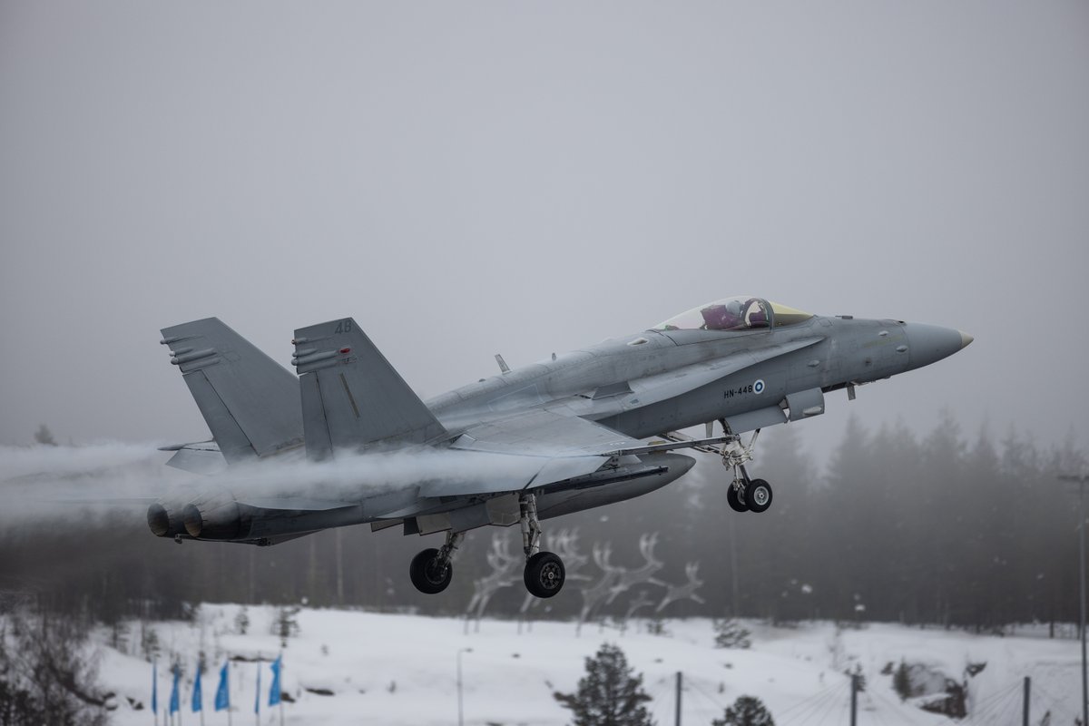 JFCNorfolk's tweet photo. 🇫🇮 Air Force F/A-18 Hornets from the Lapland Air Wing take to the skies during exercise Cold Response at Rovaniemi Air Base, while a NH90 Tactical Transport Helicopter prepares for Arctic operations. ✈️🚁

The exercise contributes to Arctic Sentry, NATO’s enhanced vigilance activity designed to strengthen Allied presence and cooperation in the High North.🤝

#WeAreNATO #ArcticSentry #StrongerTogether 
@FinnishAirForce | @DefenceFinland | @FinlandatNATO | @SHAPE_NATO | @NATO_AIRCOM