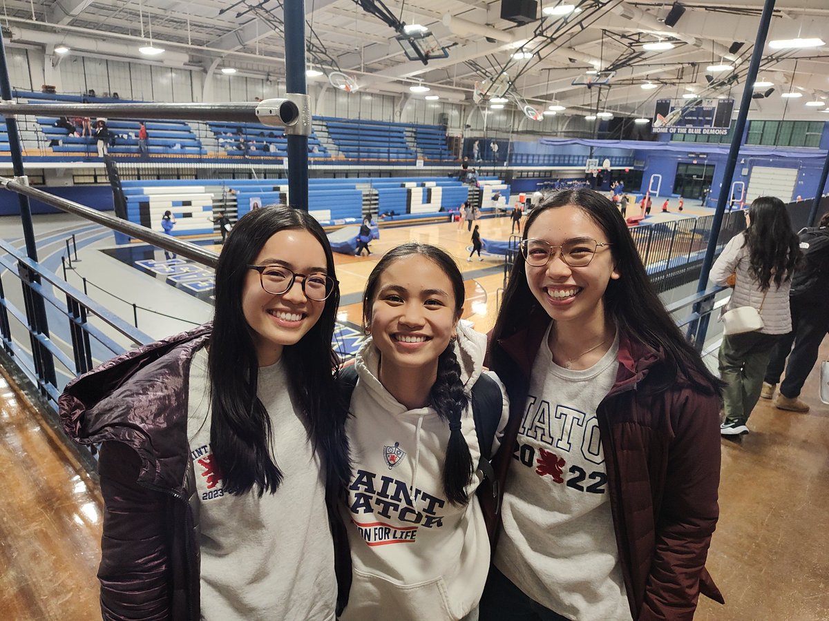 Home for spring break. Carmella and Camille flank their sister Cassie at tonight's meet after cheering her on in the 400m!
