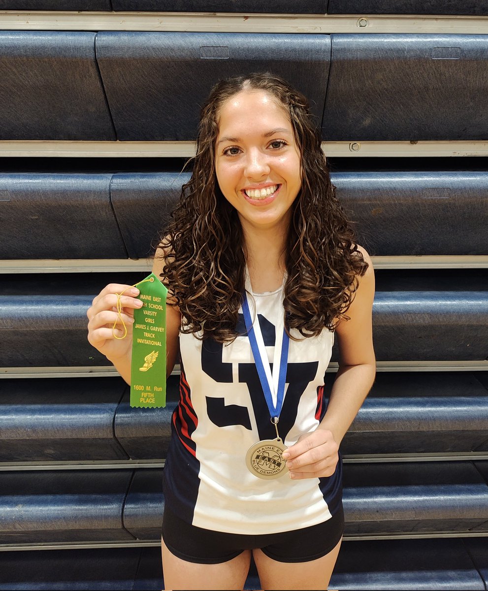 Isabella Renguso with her 5th place ribbon for the 1600m, and second place medal for the 4x800.  She looks pretty happy about them.