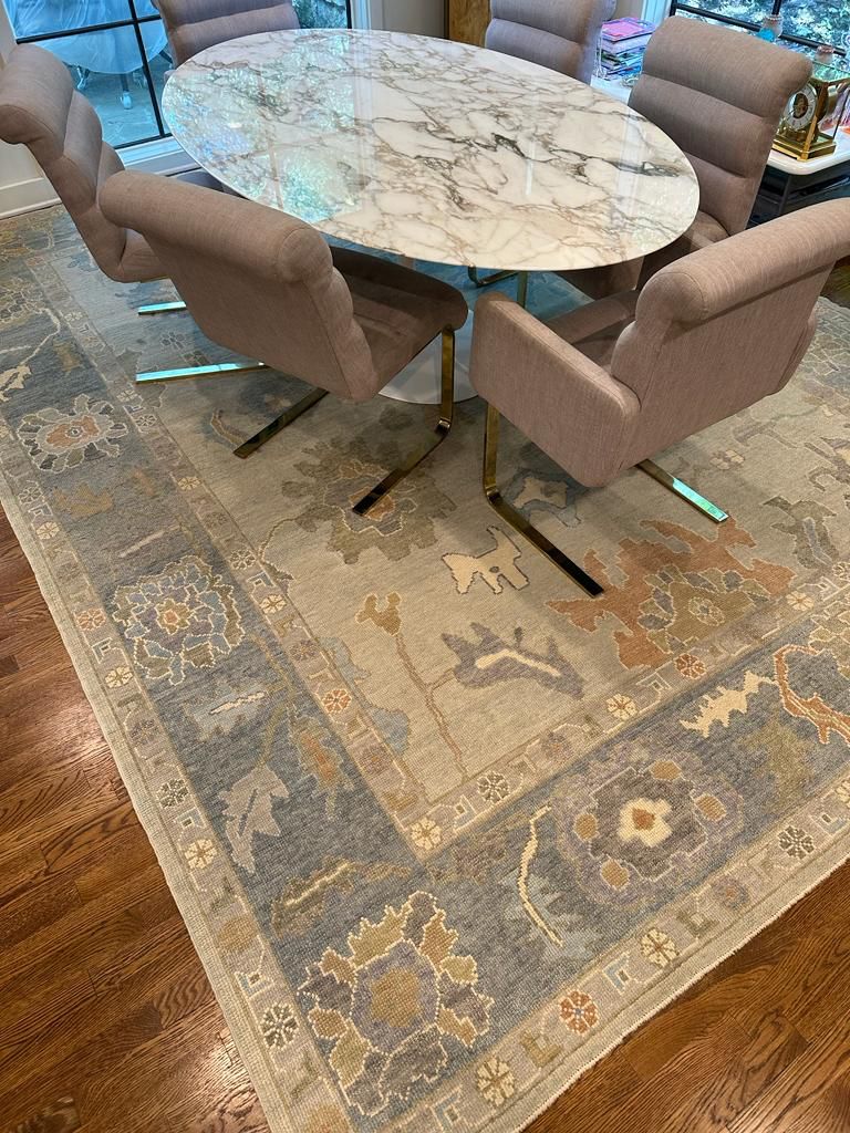 Handwoven wool rug in SLATE BLUE, BEIGE, TAUPE, and SOFT GOLD with a classic Oushak-inspired pattern. Brings quiet elegance and warmth to modern dining spaces. 
 #TurkishRugCo #OrientalRugs #DesignerRugs #HandKnottedRugs #OneOfAKindRugs #TurkishRugs #OushakRugs