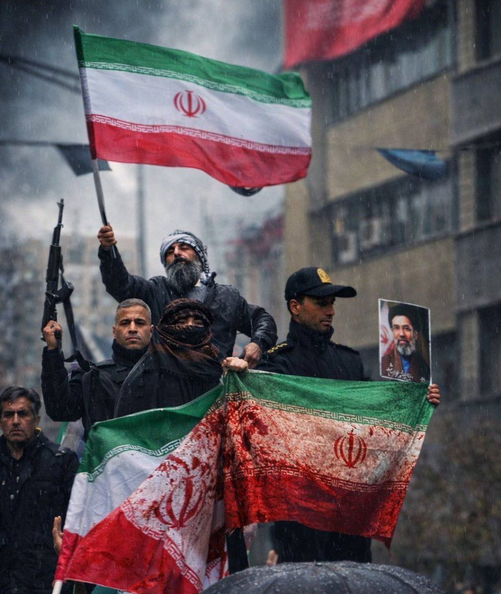 timand2037's tweet photo. Operation Epstein Fury sent a drone into the International Quds Day rally (for Palestine) in Tehran, Friday 13 March, in Engelhab Street, killing Mariam Sadat. Her blood stains the Iranian flag in this photo, taken that day by Yusuf Mozneb. https://t.co/V6sy3F7Y5Q
