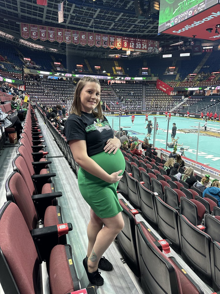 Desiraerae13's tweet photo. If I had a dollar for every time I came to a @NLLRoughnecks St. Paddy’s Day game while very pregnant, I’d have two dollars. Which isn’t a lot, but it’s weird that it’s happened twice! 
First picture is 2023, second is today #stpatricksday #pregnantaf #gonecksgo https://t.co/ZdgKVDGa0H