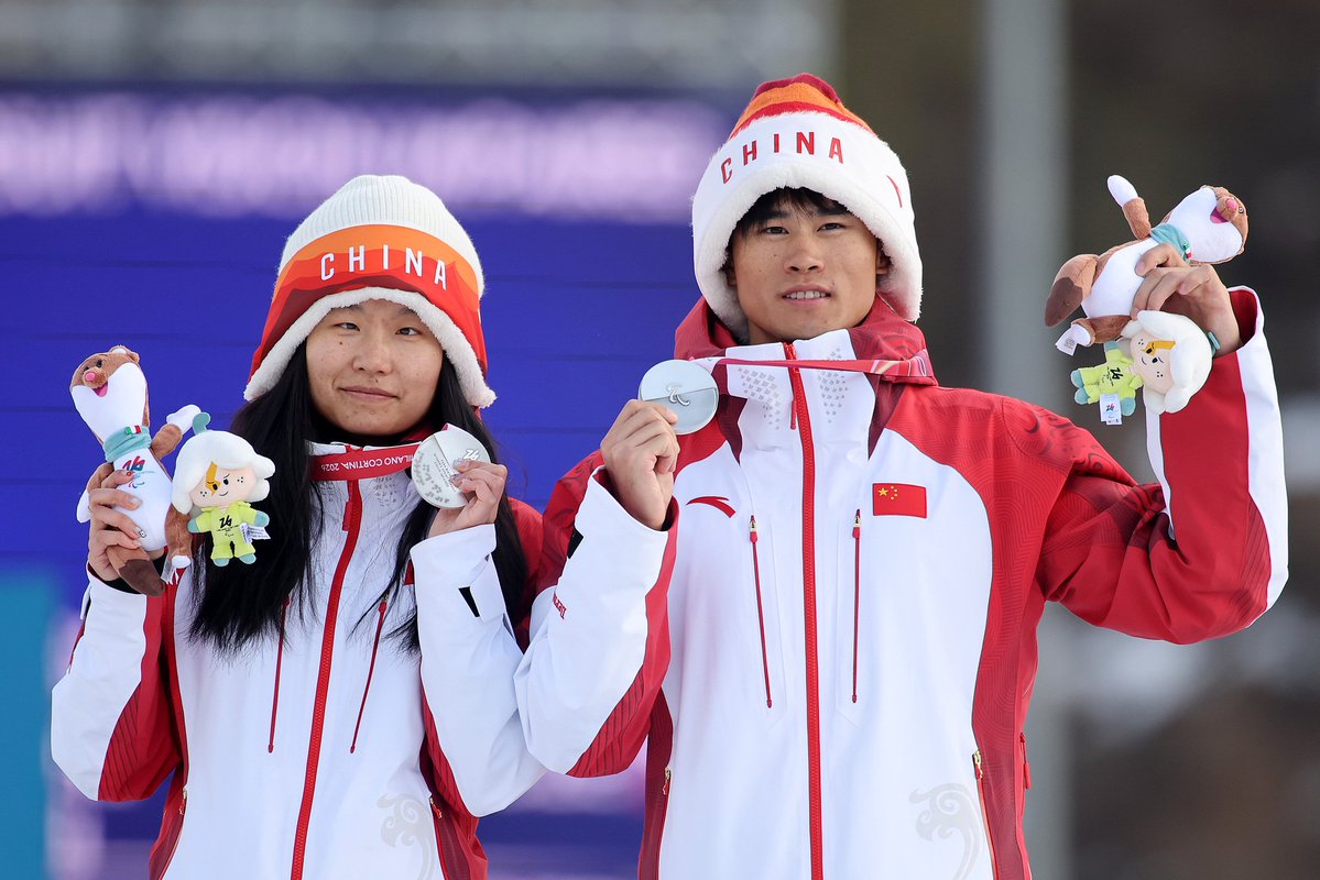 CGTNOfficial's tweet photo. #TheFaces: The unbreakable bond between athlete and guide at #MilanoCortina2026
At the 2026 Milano Cortina #WinterParalympics, some of the most remarkable competitors race not alone, but in pairs. Visually impaired athletes take to the snow alongside their guides, forming a unique partnership built on trust, precision and constant communication.
In Para alpine skiing, a guide skis ahead of an athlete and relay course information through headsets. Before the race, the pair reviews the route together and mentally runs through the course, building rhythm and mutual understanding.
Similar partnerships can also be seen in Para cross-country skiing and Para biathlon. For visually impaired athletes, guides are more than teammates. They are the athletes' eyes on the track, supporting every moment behind the spotlight. #Paralympics