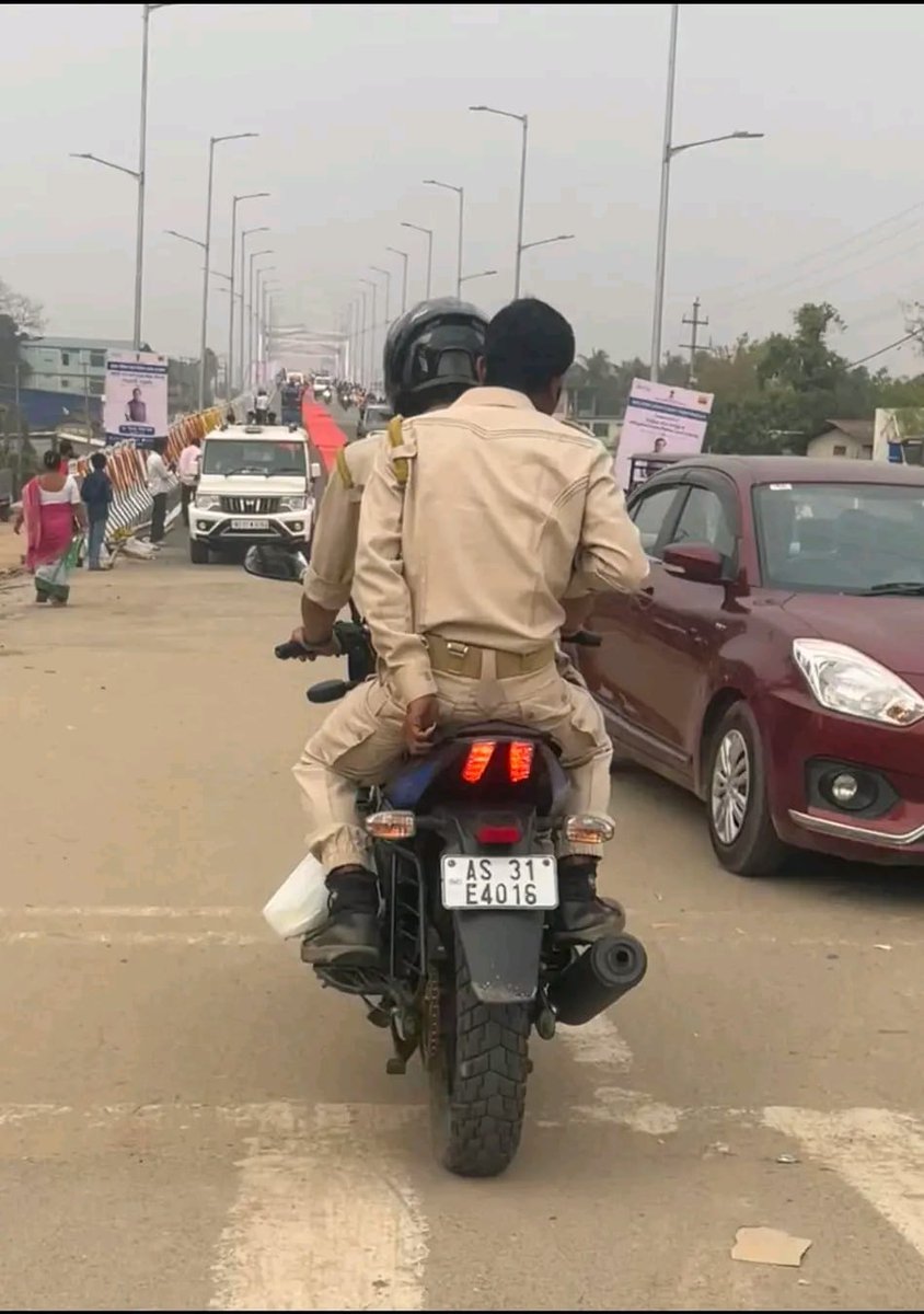 Dhun655's tweet photo. @assampolice without helmet. Will you take action? https://t.co/6BgWYaa4Y1