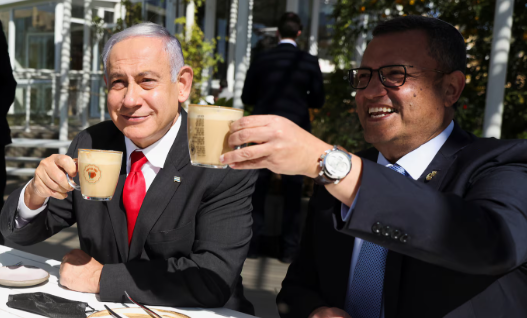 alphanewsupdate's tweet photo. @dom_lucre PM Netanyahu just released a coffee shop video to debunk death rumors: I m alive, here's my five fingers, not six  Sipping coffee, roasting conspiracies, and telling Israelis to stay strong near shelters. Legend move amid Iran strikes. He's fine, folks.  #NetanyahuAlive https://t.co/7xVSVLjWWn
