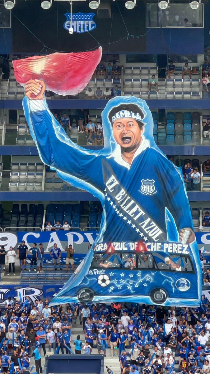 La hinchada de Emelec rinde homenaje al histórico hincha Eduardo “Che” Pérez con un enorme telón desplegado en el estadio, recordando su legado y su lugar en la historia de la Barra Azul.