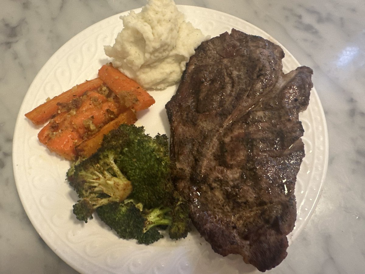 Pork steak, garlic mashed potatoes, roasted broccoli and garlic Parmesan roasted carrots. 

No I’m not gonna eat that whole steak. 😊

My Son approves.