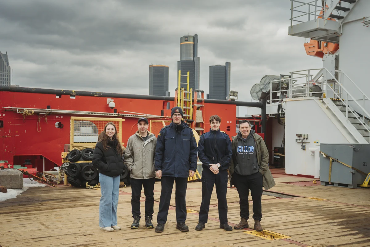 a group of people standing aboard the CCGS Vincent Massey