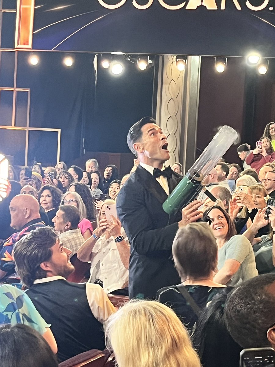 hoffer_lisa's tweet photo. @kellymarklive Mark enjoying the t-shirt gun! #oscars https://t.co/fvFmIxGtPv