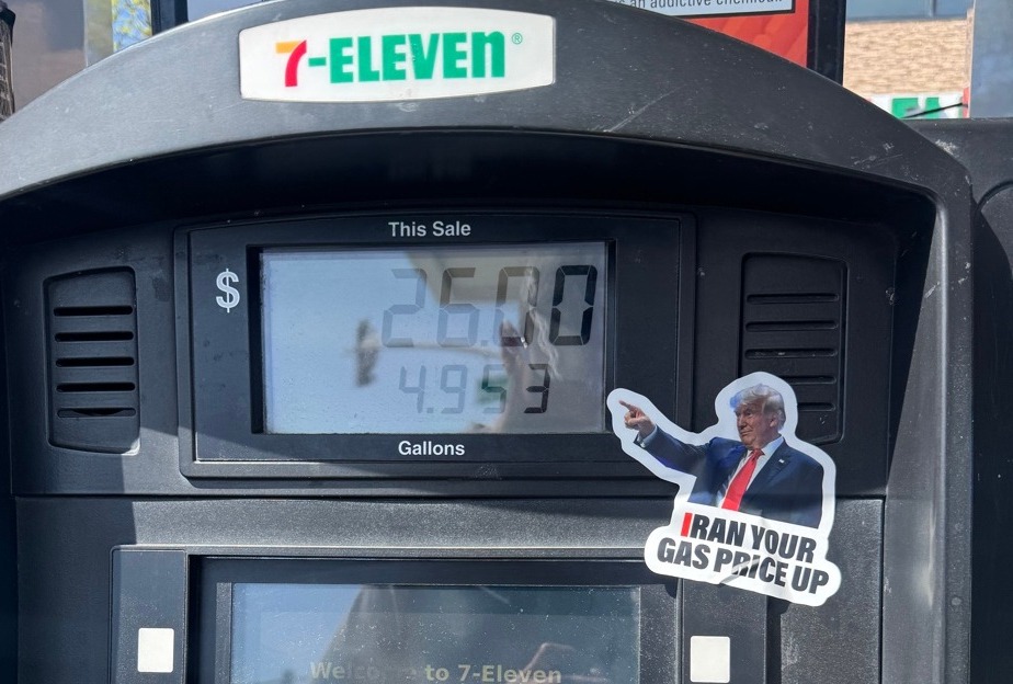 Trump I Ran Your Gas Price Up sticker on gas pump at 7-Eleven showing $4.95 per gallon