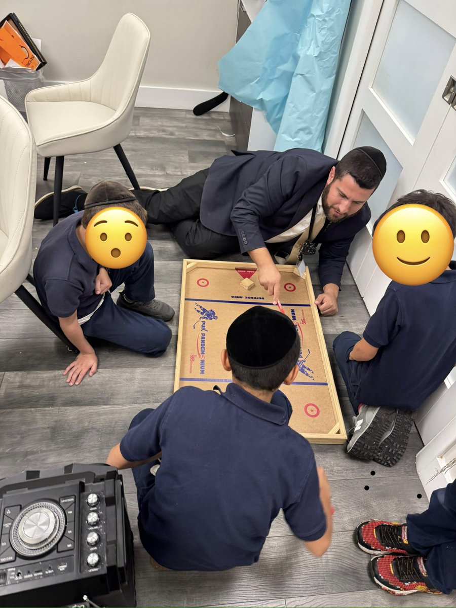 Teaching the younger generation about Nok Hockey. Who needs a screen?