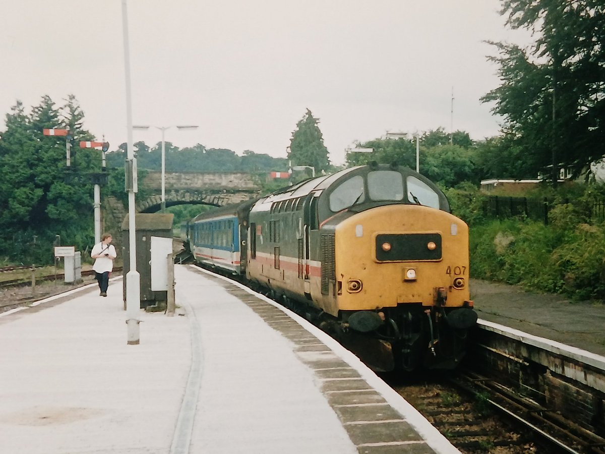 Invermuir's tweet image. Tractors and pegs. 37407 trundles into Pen Mill in 1992 with a Weymouth -Bristol Temple Meads service.#tmrguk #class37 #tractors @TheGrowlerGroup