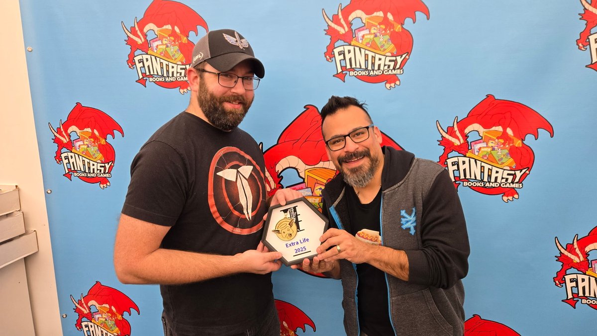 ExtraLifeSTL's tweet photo. @Mad_Dawg_Mike went and presented Fantasy Books and Games with their @ExtraLife4Kids gold metal for the wildly successful Warhammer event they organized together in October. 

Fun Fact: Mike printed that display for them! He was very proud of himself https://t.co/LViS0ypXlX
