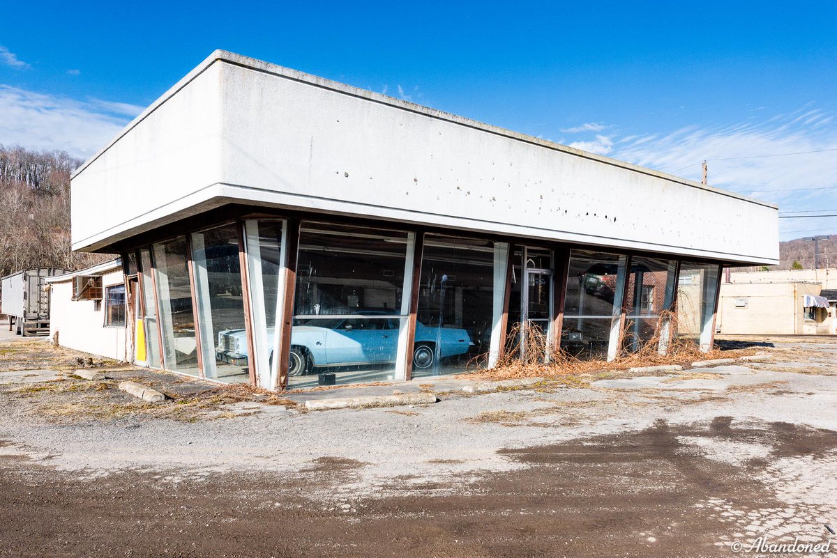 An abandoned dealership, Mark Motors. 

You can still spot A baby-blue 1978 Plymouth Fury and a tan 1980 Chrysler Cordoba in the showroom as though awaiting customers who would never arrive