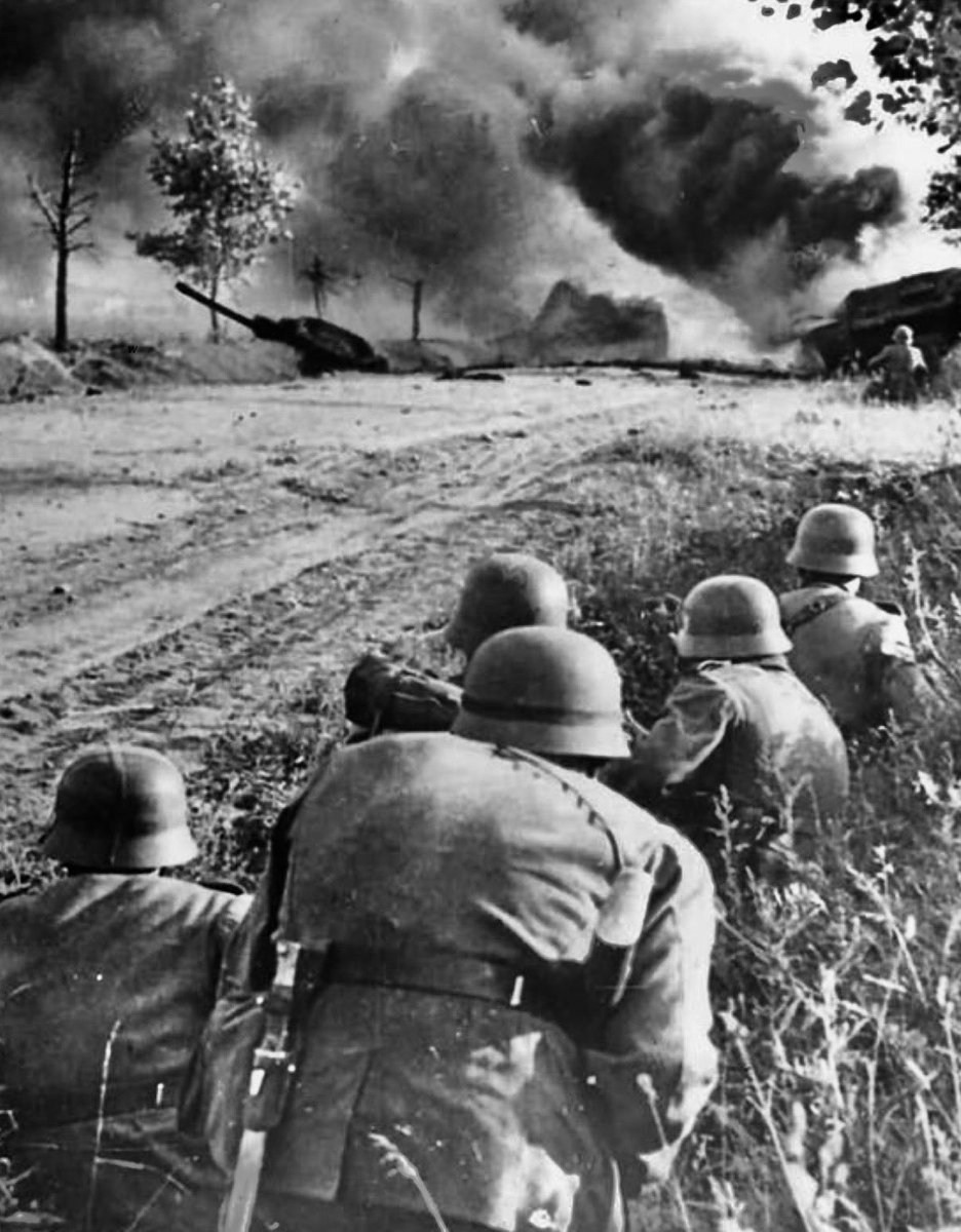 TheWorldatWar2's tweet image. German Soldiers take cover as a Soviet tank is destroyed - Eastern Front 1941 #ussr #sovietunion #tank #ww2history