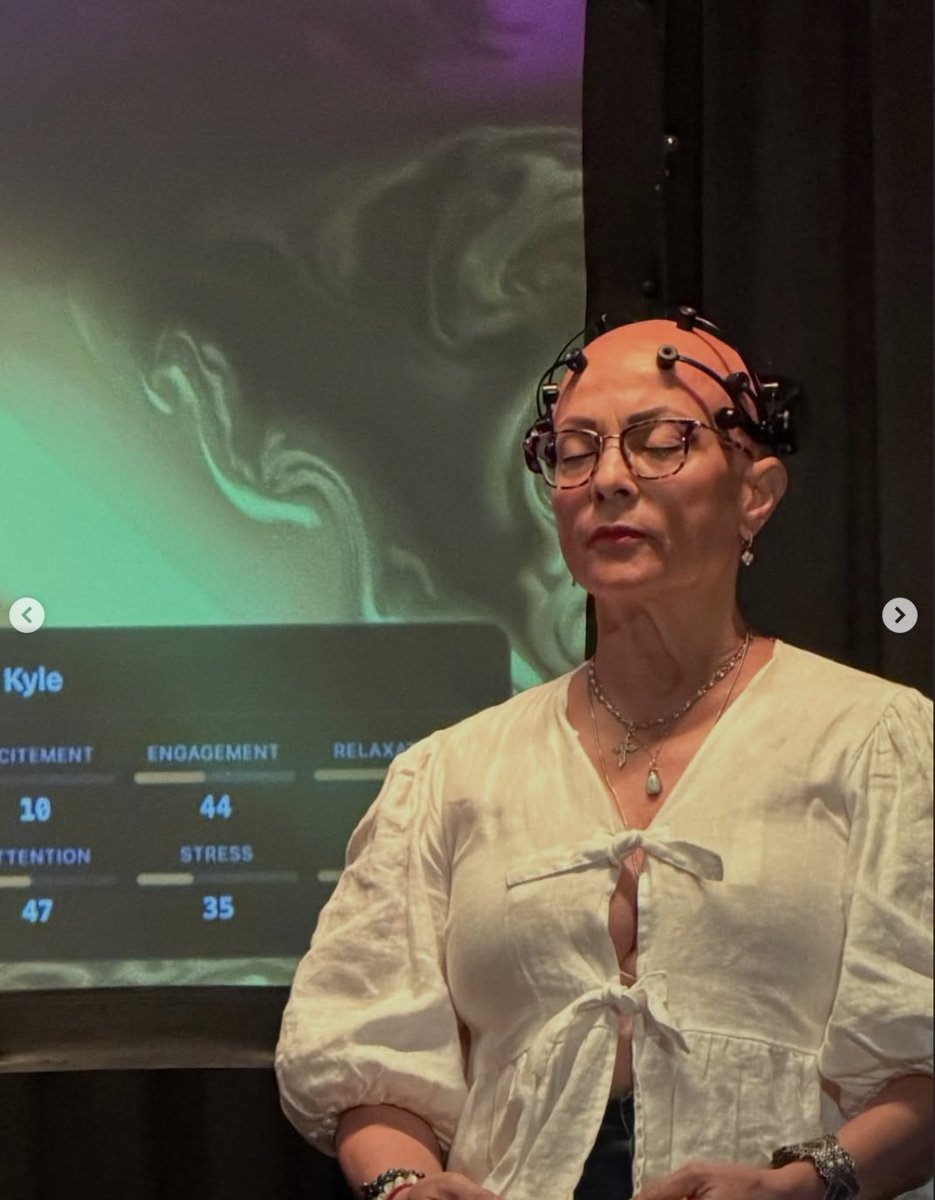emotiv's tweet photo. At Biometric Study: Connected Art, composer Nathalie Bonin performed live alongside 3 participants wearing EEG headsets. Their brain activity was measured and used to generate evolving visuals in real time, creating a shared environment shaped by both music and human physiology. https://t.co/i2xeous5I6