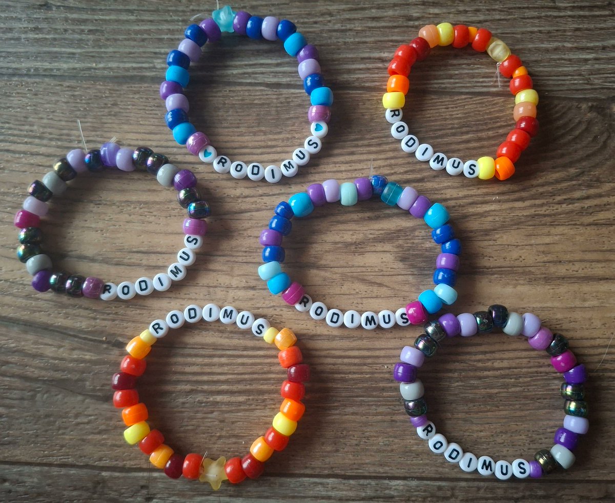 xSeaI3ellx's tweet photo. Some Shattered Glass bracelets & various Rodimus bracelets. 💜🩵🔥❤️💛 I really like SG Ratchet's colors! #Transformers #ShatteredGlass #Decepticons #Autobots #HotRod #Rodimus #Ratchet #OptimusPrime #Soundwave #Ravage #LostLight #IDW https://t.co/GRNU0JmFze
