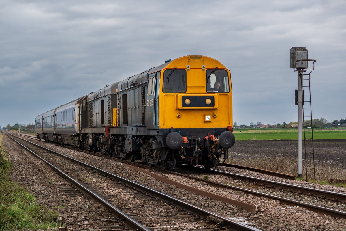 chriss_photos1's tweet image. Romic owned and Rail Adventure operated 20205 &amp;amp; 20007 pass Beild Drove near Ely with 5L26 ex Burton Wetmore, conveying three Mk 3 coaches to the Mid Norfolk Railway on 01st April 2026. #Class20 #UKRailways #RailwayPhotography