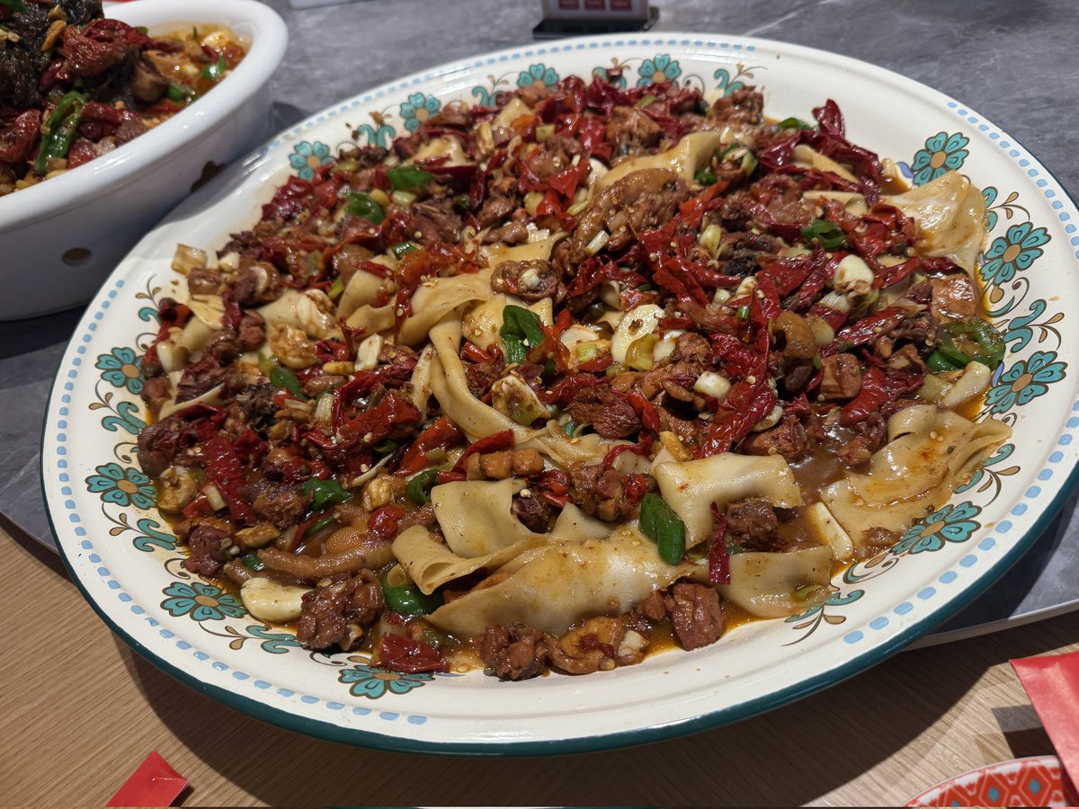 ：Hunt for crispy chicken in a sea of chilies, bold and spicy, a classic favorite for food lovers.